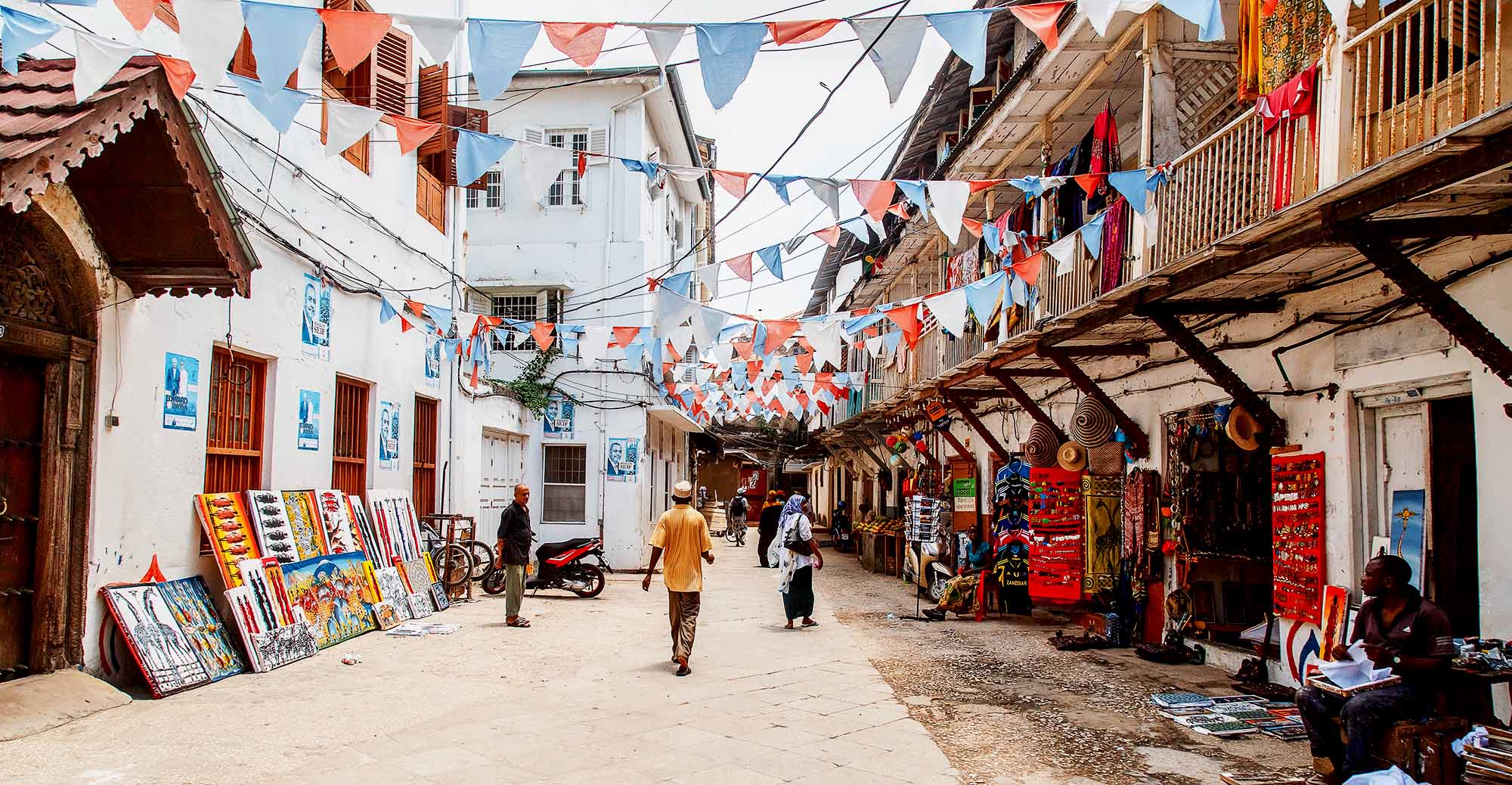 Local people on a street in Stone Town. Stone Town is the old part of Zanzibar City, the capital of Zanzibar, Tanzania